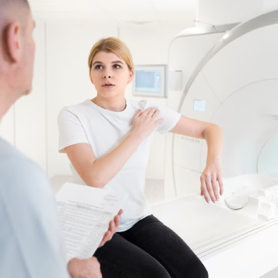 Patient consulting doctor before MRI scan for shoulder pain in diagnostic imaging center