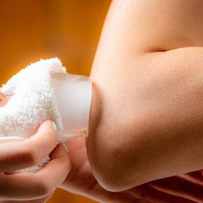 Ice massage therapy applied on elbow for pain relief and recovery