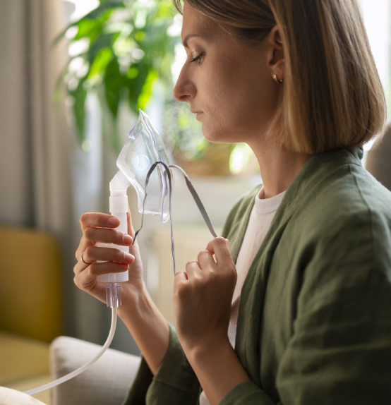 Woman holding oxygen mask for respiratory therapy at home